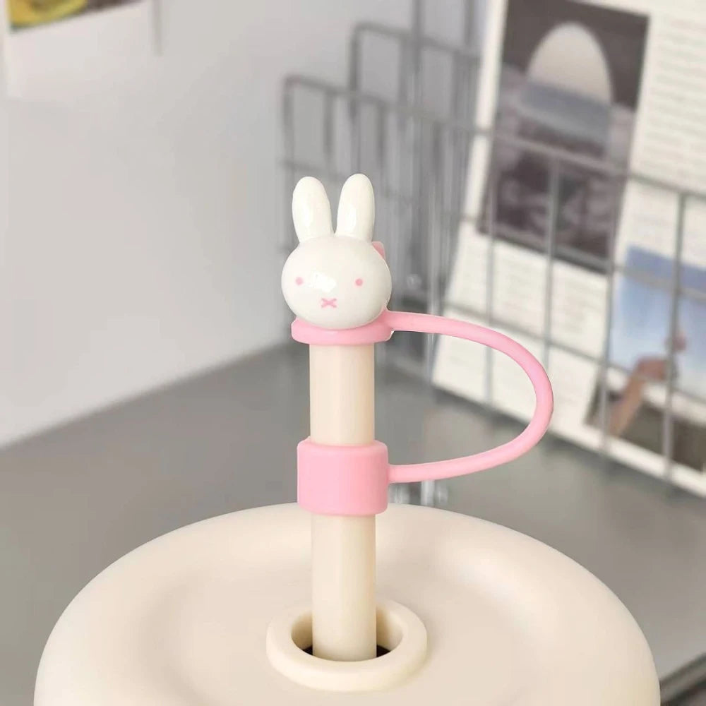 A white Miffy straw topper with a pink dust cover is shown on a light-colored surface.