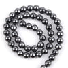 A strand of small, dark, polished beads made from natural sea sediment jasper and turquoise for jewelry making