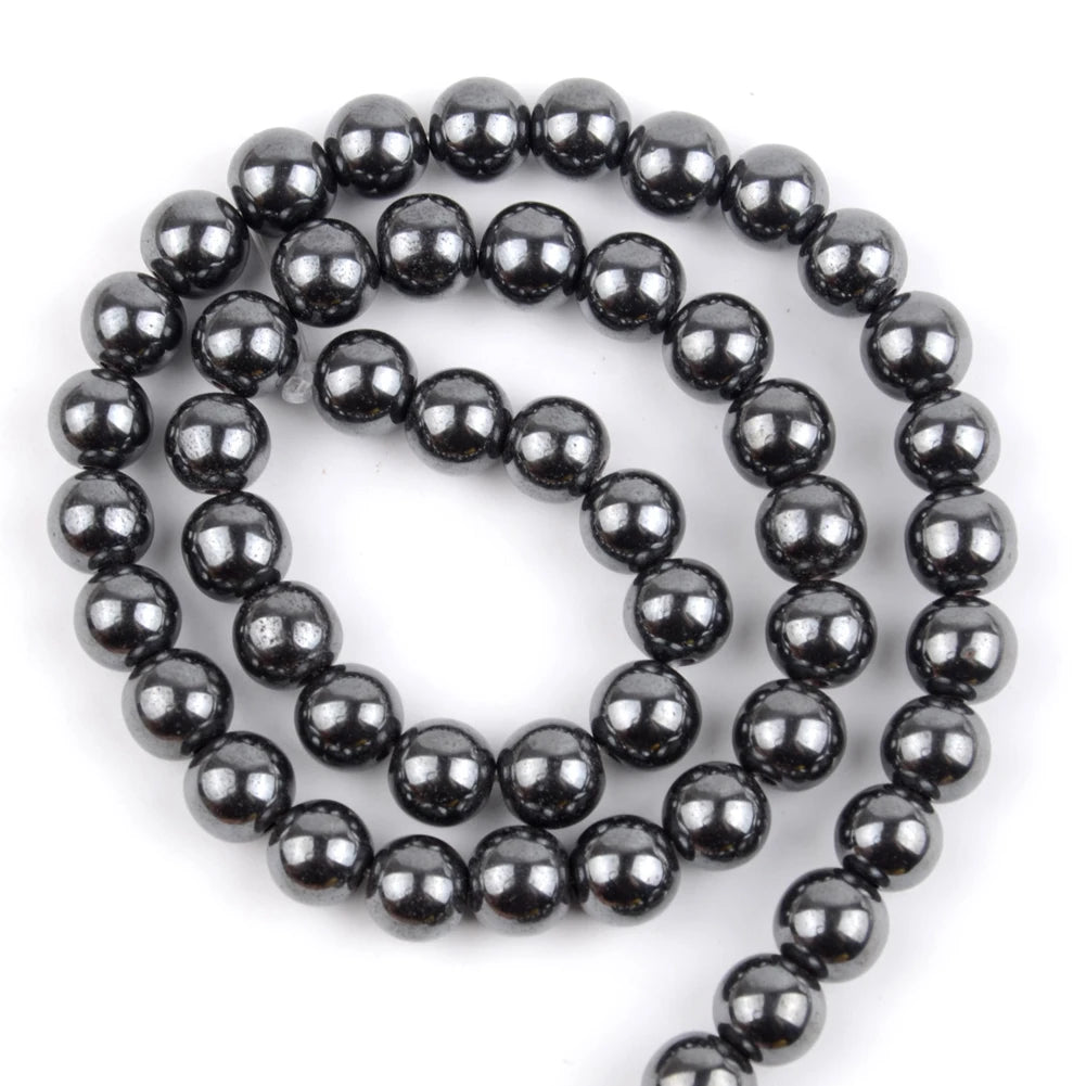 A strand of small, dark, polished beads made from natural sea sediment jasper and turquoise for jewelry making