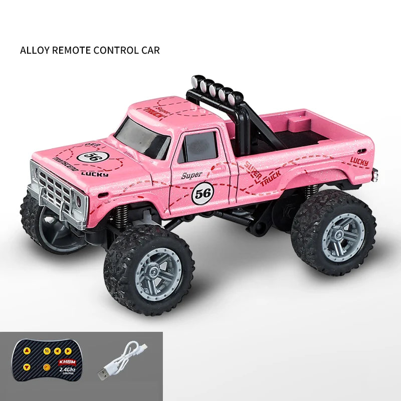 Pink alloy remote control truck with large tires and a controller and battery.
