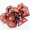 A set of premium metal polyhedral dice with a multicolor gold finish scattered on a white surface.