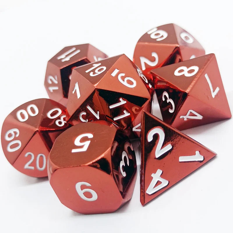 A set of premium metal polyhedral dice with a multicolor gold finish scattered on a white surface.
