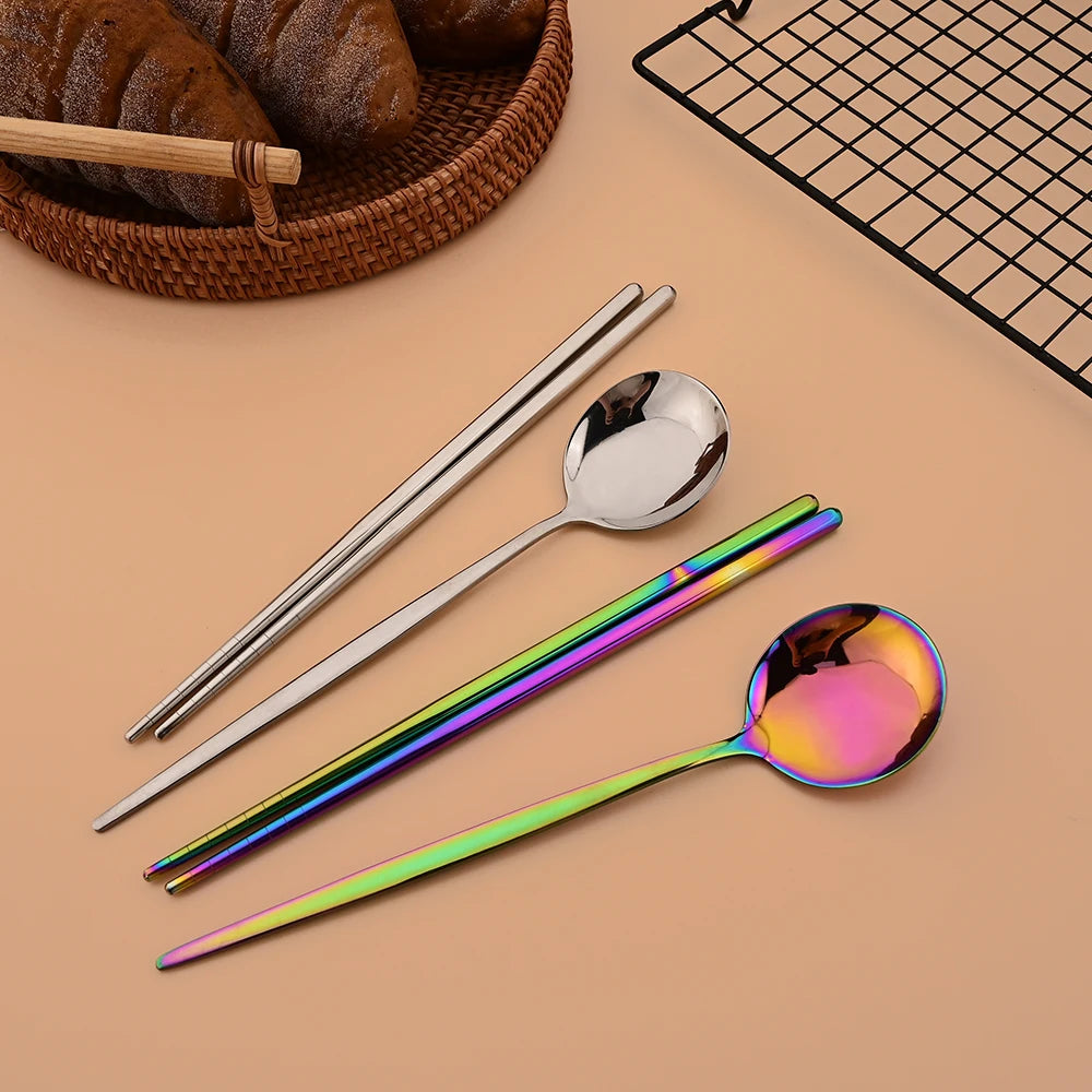 A set of six stainless steel Korean dinnerware including chopsticks and spoons is displayed on a light background.