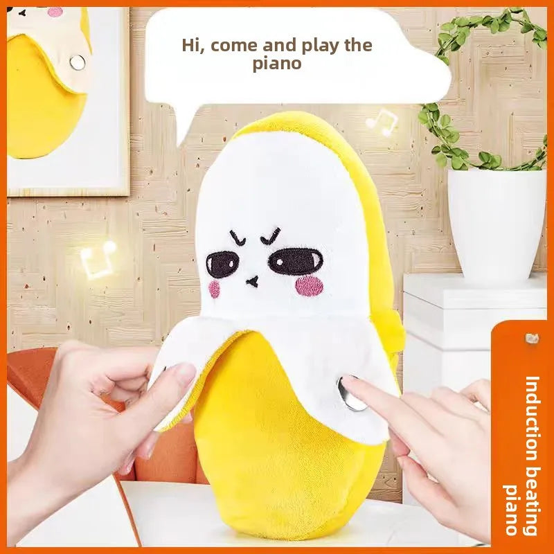 A yellow and white fruit-shaped plush toy designed as a musical piano for interactive play.