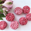 A set of realistic pink rose silicone molds for candle, soap, and crafting.