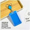 A bright blue plastic ID badge holder with a clip and keychain is displayed on a wooden tray.