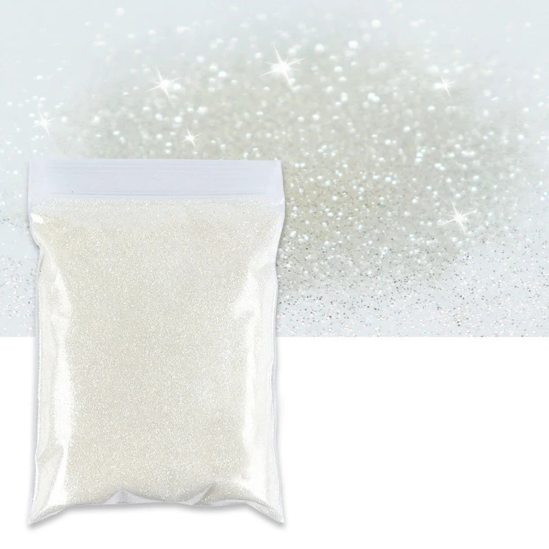 A clear plastic bag filled with fine holographic glitter powder against a sparkling white background.