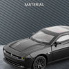 A black Dodge Challenger SRT Hellcat diecast model car is shown in a studio setting.