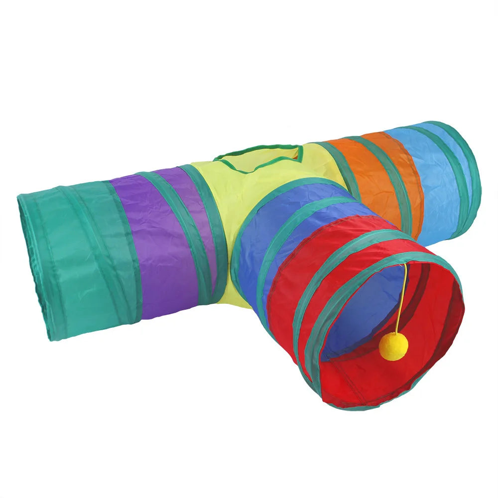 A colorful foldable S-shaped cat tunnel with various colored fabric tubes and a hanging yellow ball toy.