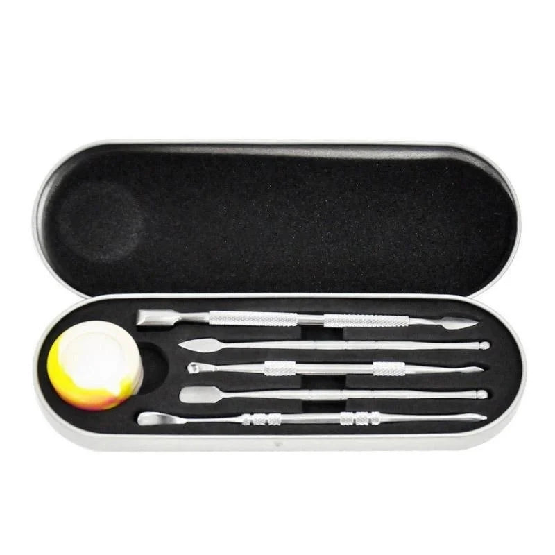 A stainless steel wax carving tool set with silicone container and travel case displayed in an open black box.