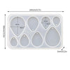 A white silicone mold set with multiple geometric shapes for making epoxy resin earrings and pendants.