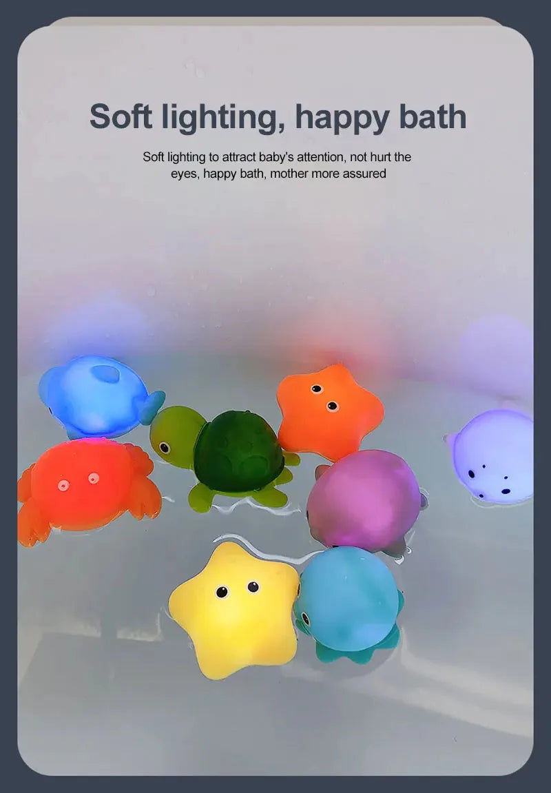 A collection of colorful, soft LED light-up bath toys floating in clear water.