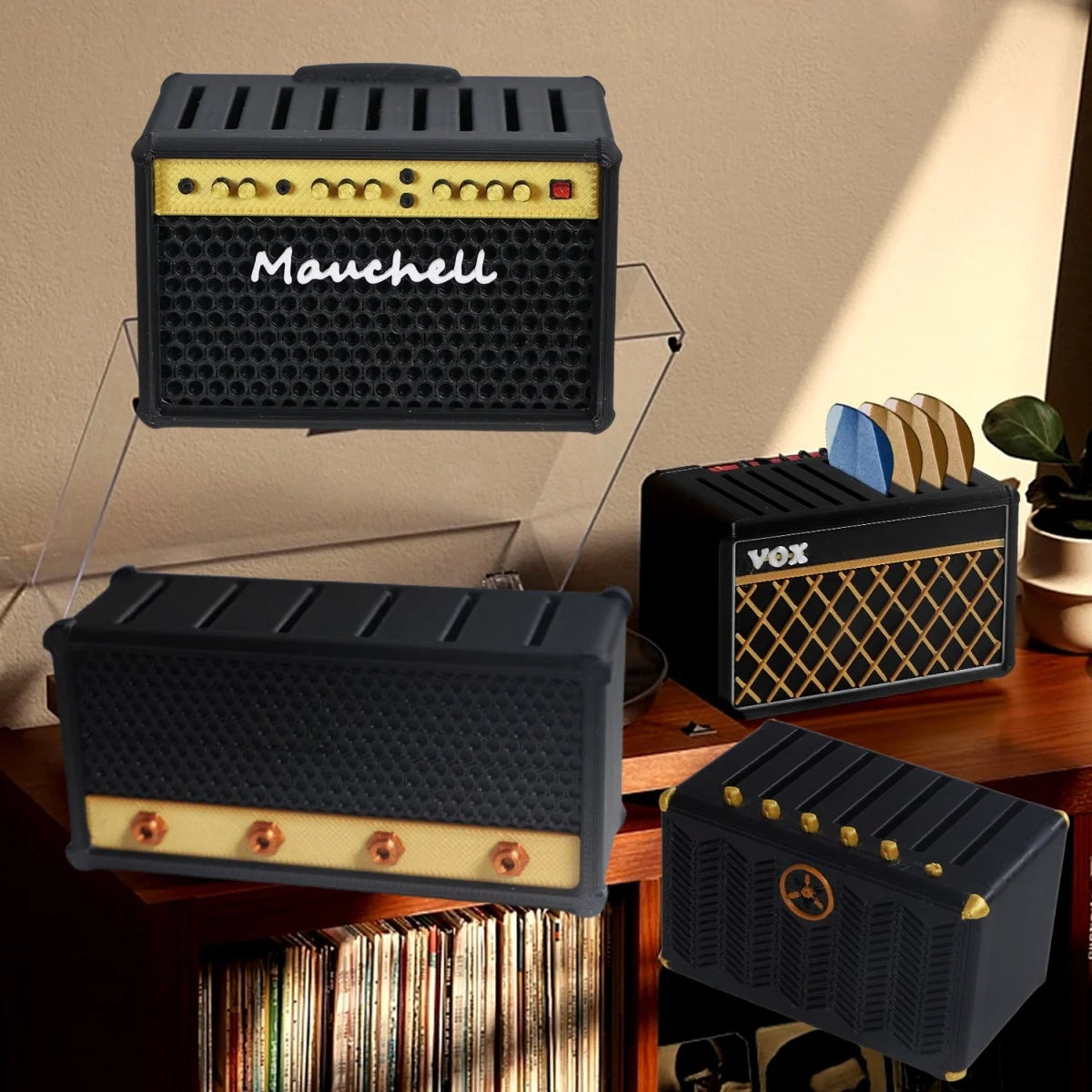 A black speaker-shaped guitar pick holder with gold accents is displayed on a wooden surface.