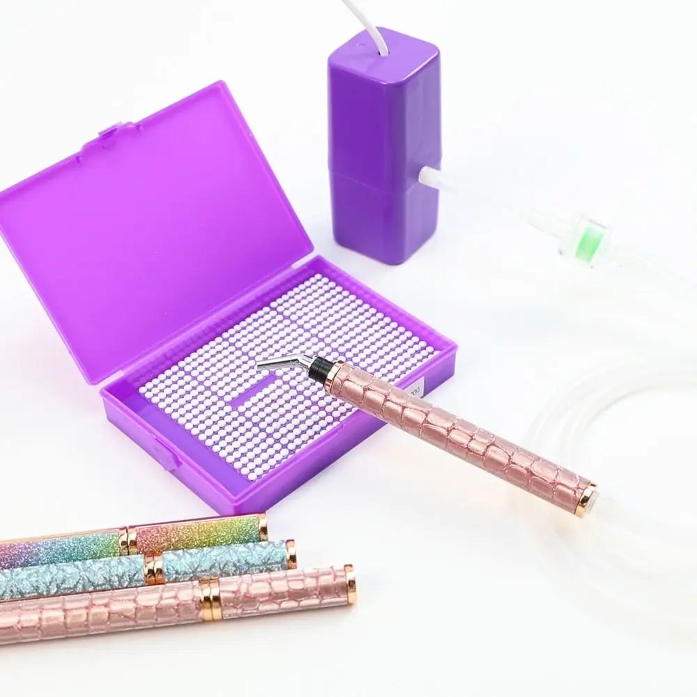 A purple electric diamond painting pen kit with a pink metallic pen and a purple storage case.