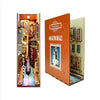 A DIY book nook kit featuring a detailed miniature scene with LED lighting and a dust cover.