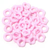 A pile of pink acrylic doughnut spacer beads for jewelry making