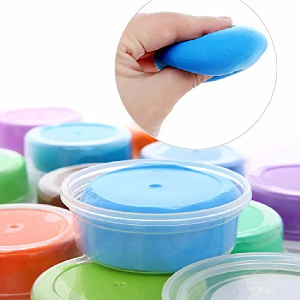 A hand holds a bright blue modeling clay, surrounded by various colored clay containers.