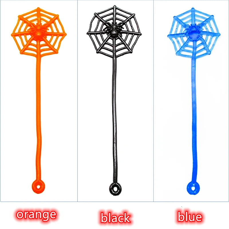 Three colorful stretchy spider web toys in orange, black, and blue for party favors or prizes.