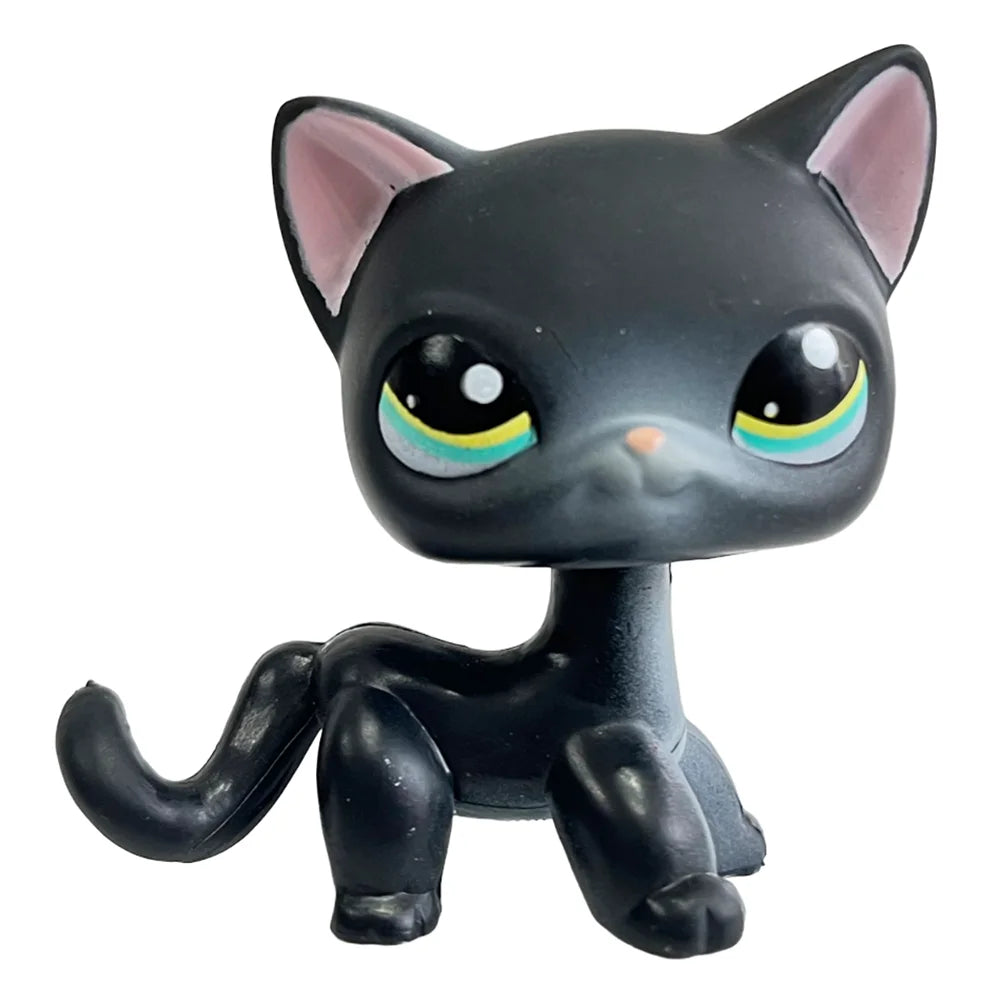 Schwarze Sammlerkatzenfigur mit großen grünen Augen und rosa Innohr.