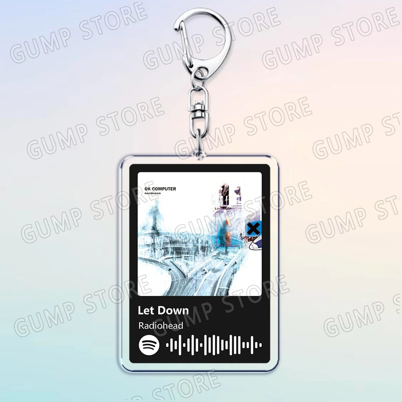 Silver acrylic keychain featuring a graphic design and the text Let Down on the bottom.