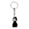 Silver keychain featuring a black silhouette of a person with hair tied up.