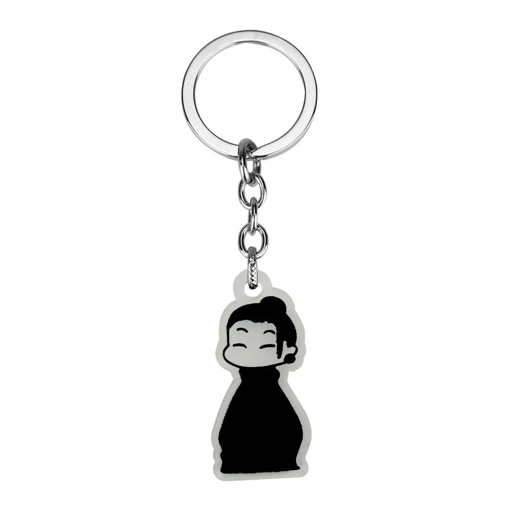 Silver keychain featuring a black silhouette of a person with hair tied up.
