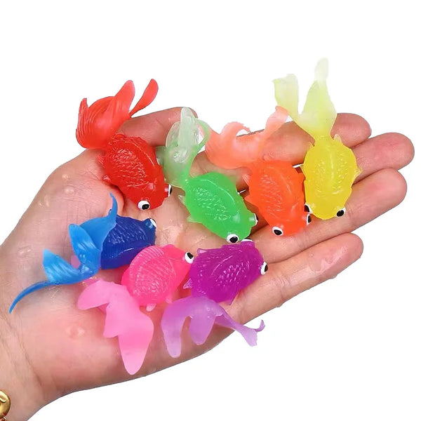 A hand holds a set of colorful simulated goldfish bath toys in various shades of orange, red, green, yellow, and pink.