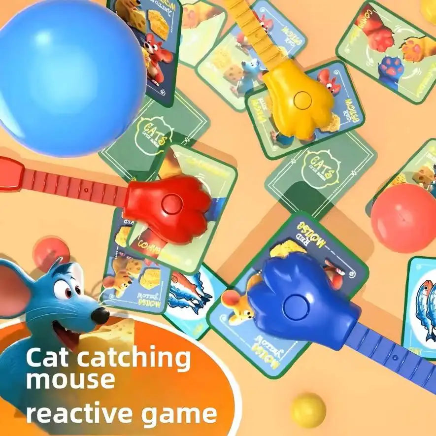 A collection of cat and mouse themed board game components including a blue ball, red and yellow toys, and game cards.
