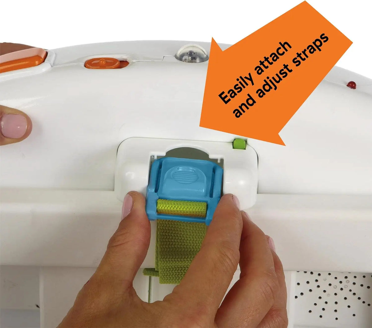 A hand is attaching or adjusting a teal strap on a white ocean-themed crib soother device.