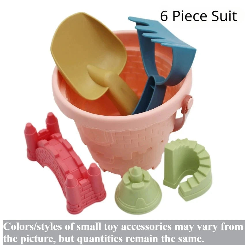 A 6 piece sand play set including a pink bucket, orange scoop, blue shovel, and green castle pieces.