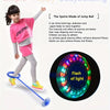 A young girl is demonstrating how to use a glowing skip ball for exercise and balance training.