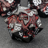 A black metal die featuring a dragon design and numbered faces, used for RPG adventures.