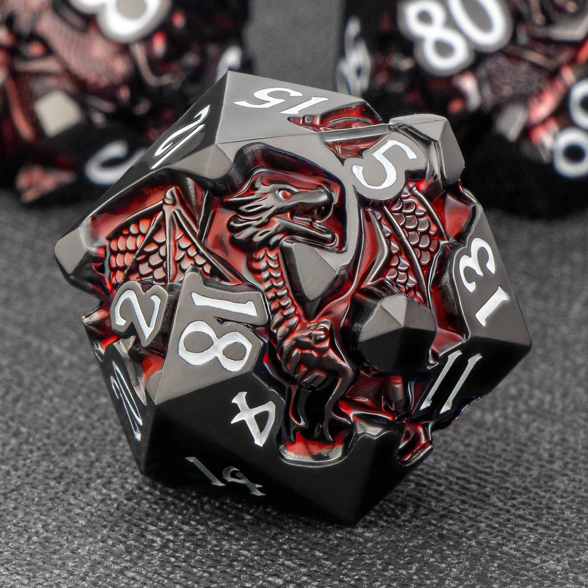 A black metal die featuring a dragon design and numbered faces, used for RPG adventures.