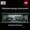 A miniature garage scene model featuring cars and figures displayed inside an underground garage setting.