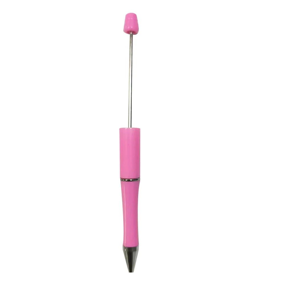 A pink beadable ballpoint pen with a silver clip and black ink.