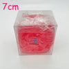 A clear plastic container holds a bright red, squishy stress ball scented with coconut oil for relaxation.