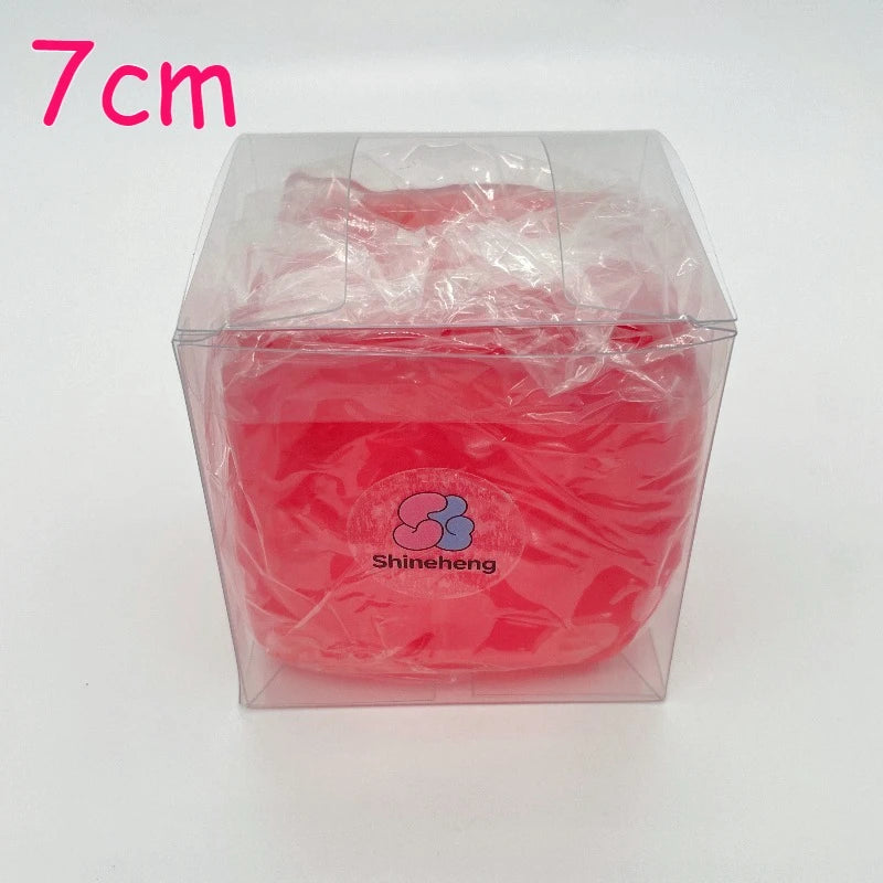 A clear plastic container holds a bright red, squishy stress ball scented with coconut oil for relaxation.