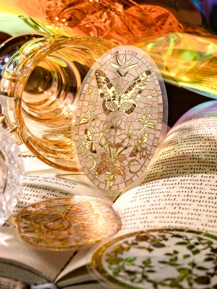 A collection of decorative PET stickers featuring gold foil designs on a page from a journal or scrapbook.