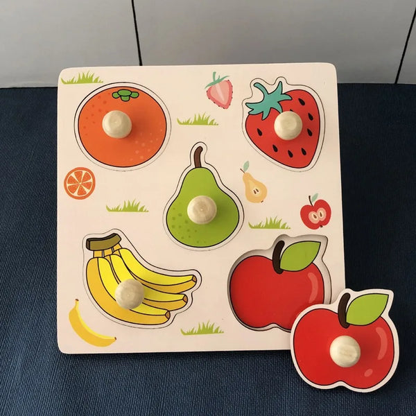 A wooden puzzle board featuring various fruit shapes like an orange, strawberry, avocado, banana, and apple.