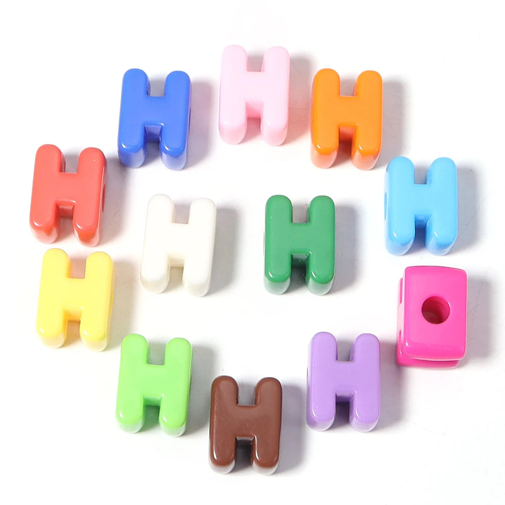 A collection of colorful acrylic letter H beads arranged in a circle.