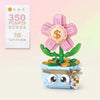 A set of pink and green floral building blocks shaped like a bouquet with a cute blue face design.