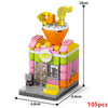 A mini city shop building block set featuring an orange and pink building with a glass storefront and yellow pipes.