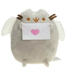 A soft gray plush cat toy with white wings holding a pink envelope.