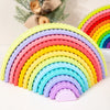 A colorful rainbow arch stack of plastic blocks in various pastel colors arranged in a semi-circle.