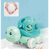 A teal rubber push and go toy car designed for babies, shown next to some white granular material.