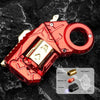 A red metal gun-shaped fidget slider key with a gold ring and various accessories is shown on a black textured surface.