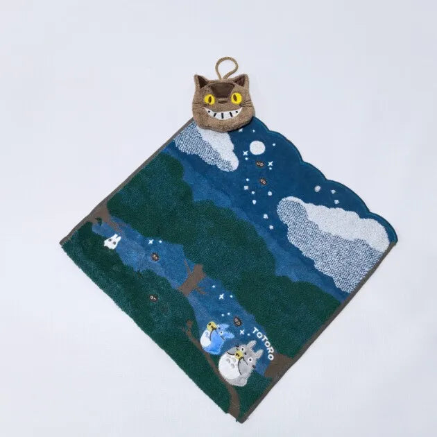 A dark blue felt rug featuring a cartoon hippo plush toy and white clouds against a night sky background.