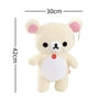A soft, cream-colored Rilakkuma anime plush bear with pink ears and a red belly button.