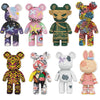 A collection of twelve small bear figures made from micro building blocks in various colors and patterns.