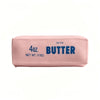 A pink butter squishy stress relief toy labeled 4oz salted butter